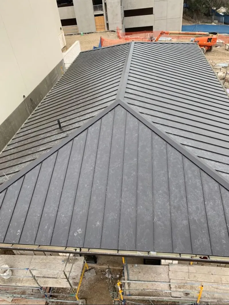 Commercial metal roof construction with crane equipment in Weiser