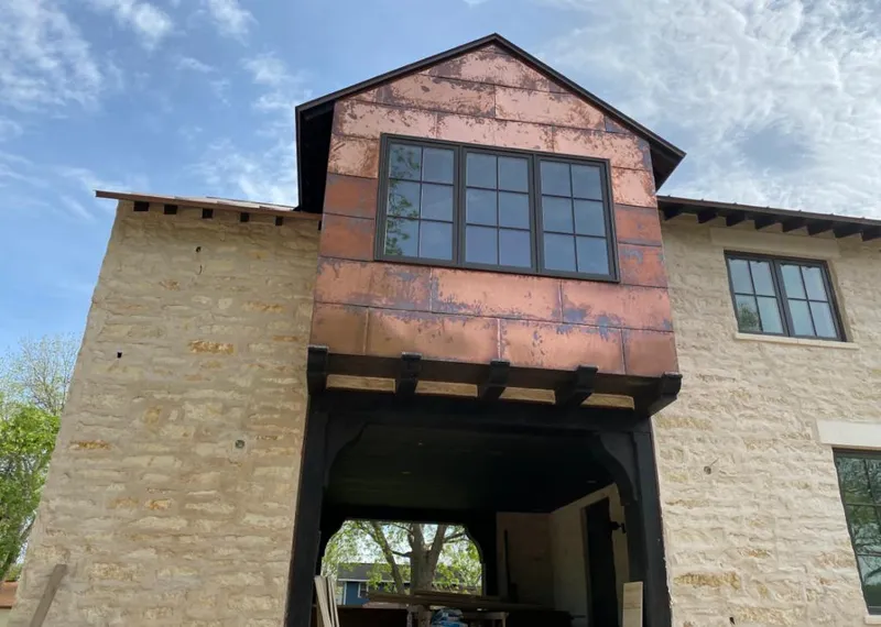 Copper metal panel facade on a stone building for Skylight Installation in Weiser